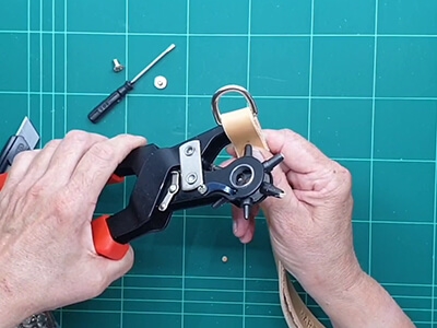 Step 5 Fold the leather around the D-ring and make a hole for the Chicago screw