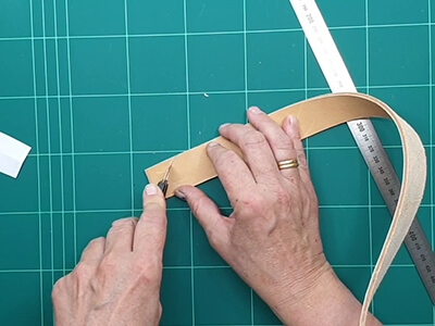 Step 2 Cut one end of the belt to a point