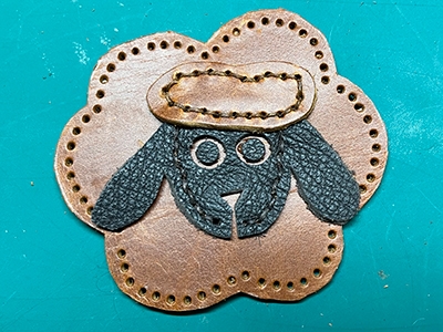 Step 6 Glue the eyes and optionally ears onto the sheep's body