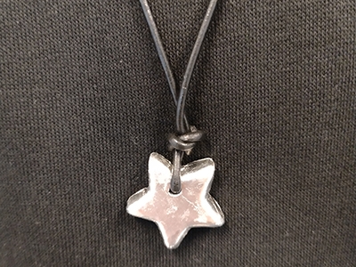 Step 12 Finished tin pendant on a leather cord to use as a necklace