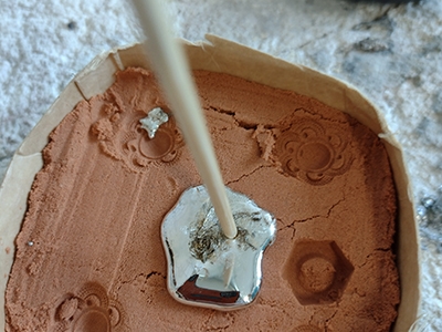 Step 8 Pour the tin into your impression in the molding sand